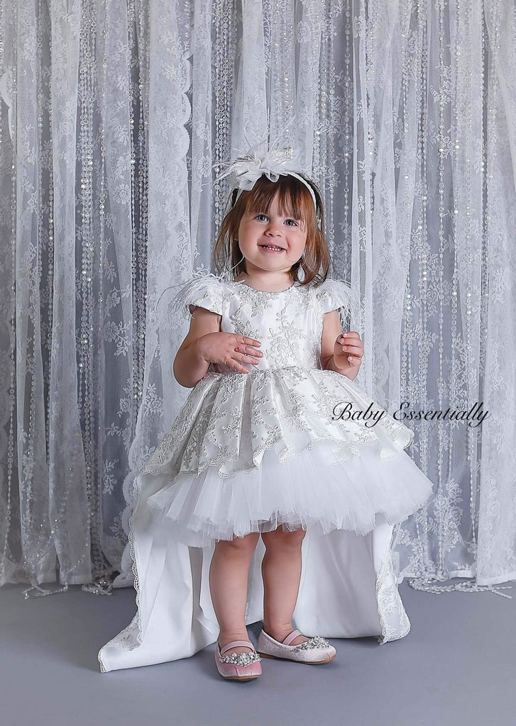 White high low, lace overlay dress. Front knee length. Bow head piece 